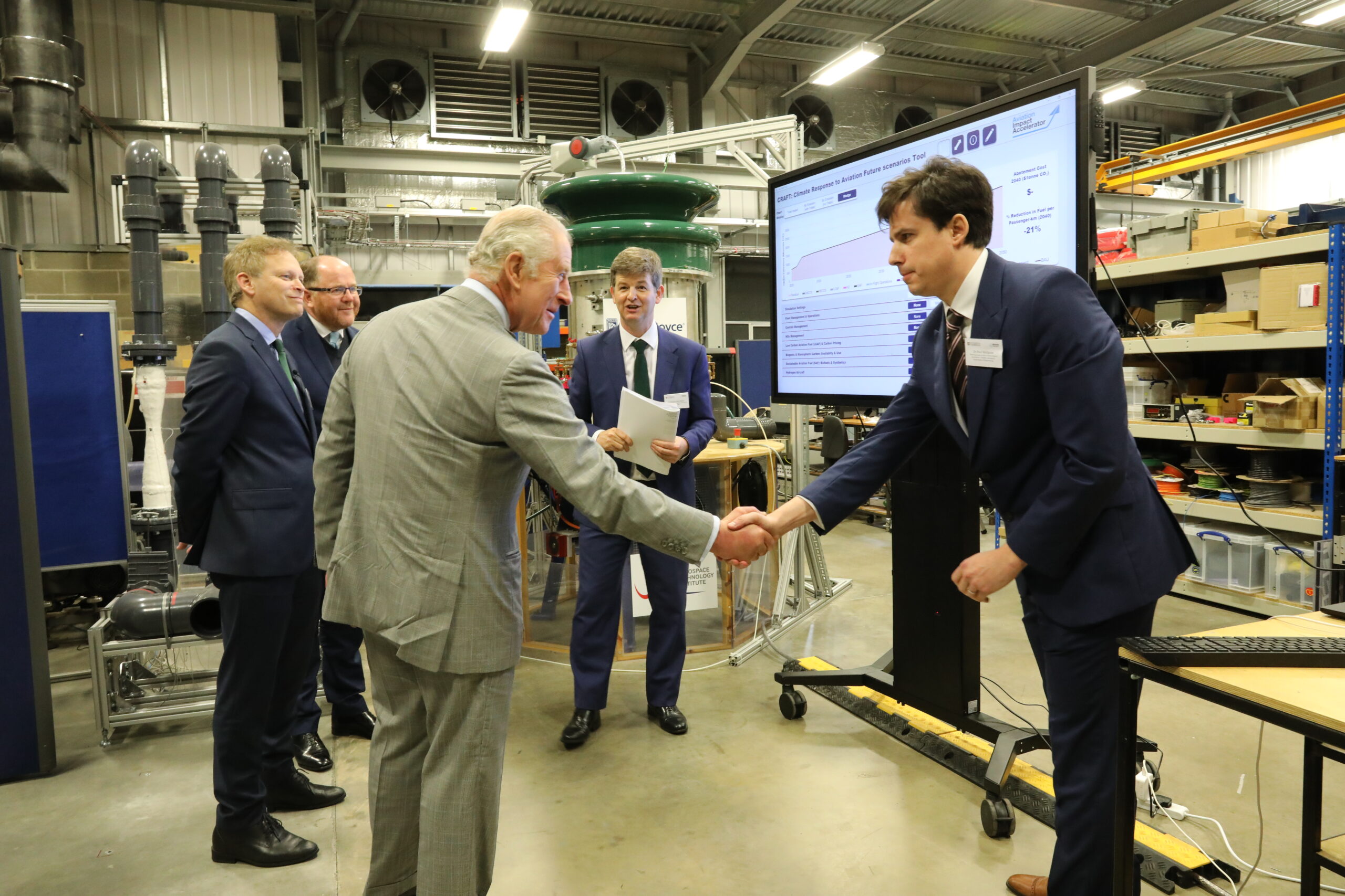 His Majesty The King greeted by Dr Paul Hodgson, Technical Lead, Aviation Impact Accelerator. Also pictured: the Rt Hon Grant Shapps MP, Prof Rob Miller, and George Freeman MP