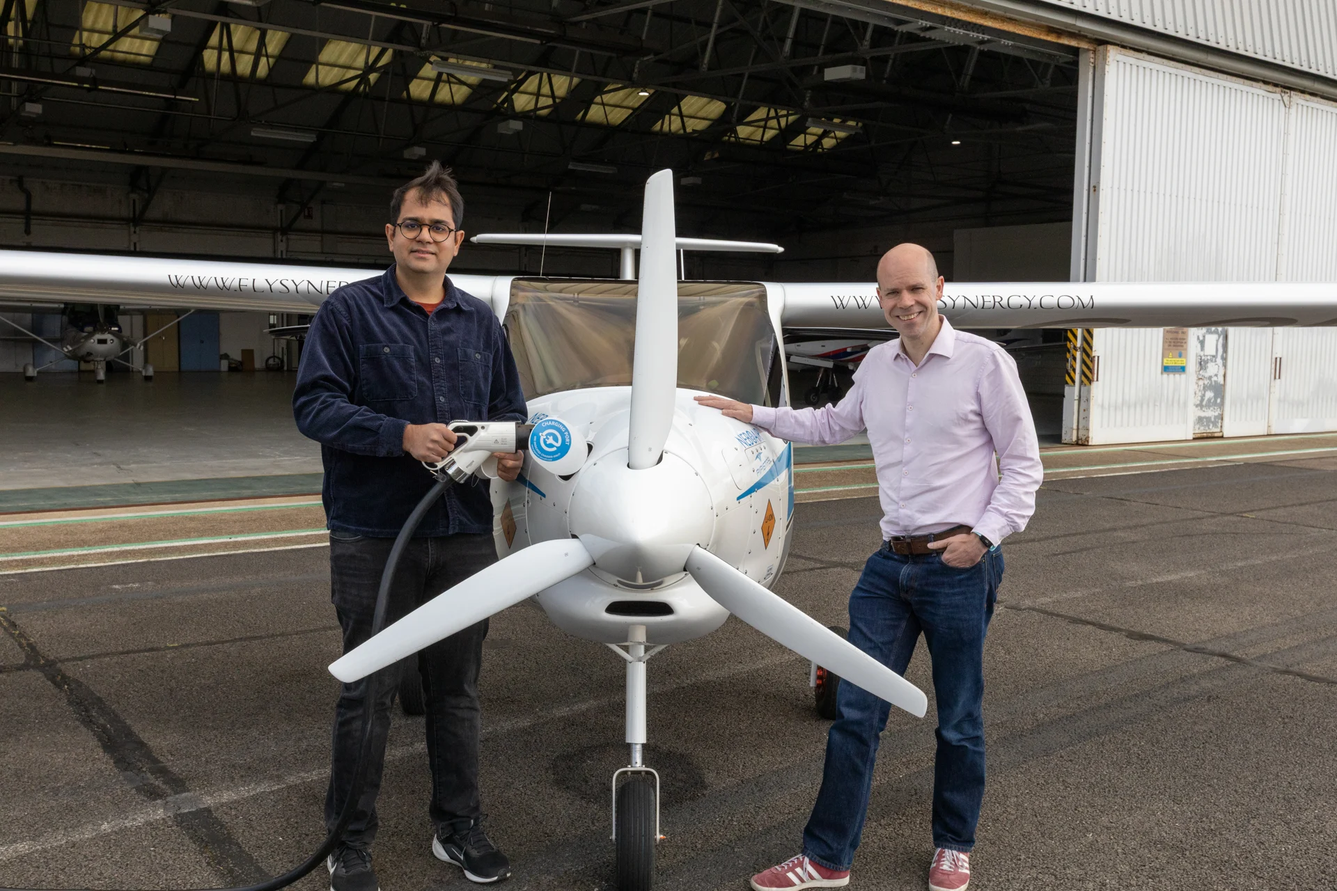 Dr Deepanshu Singh and Eliot Whittington stand next to the electric Pipistrel Velis Electro aircraft. Credit: Maisie Ormrod